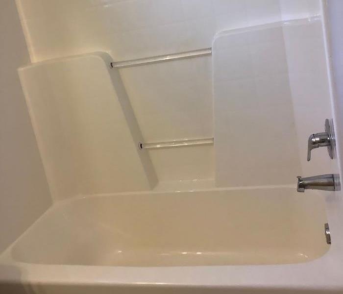 Clean bathtub with white walls